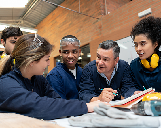 Students and apprentices listening to a tutor.